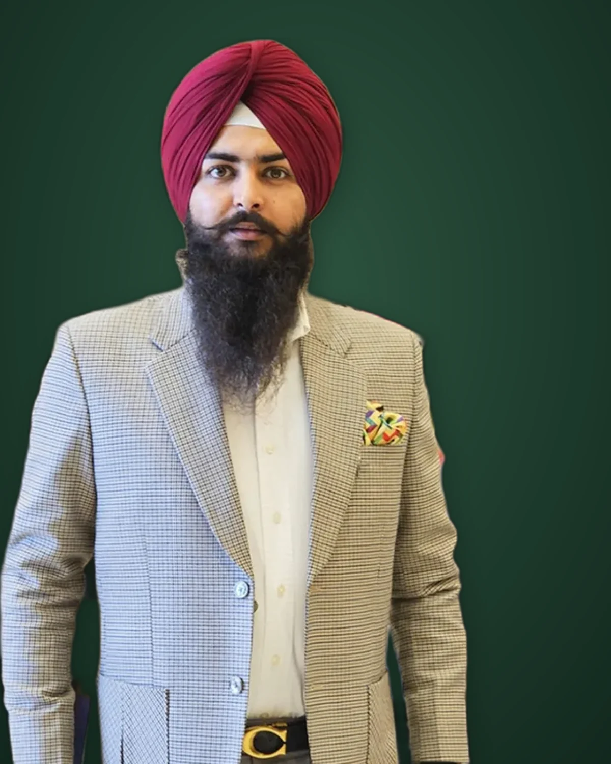 A client of the house in a maroon turban and gun-club check jacket, from Punjab Fabrics' own Instagram.
